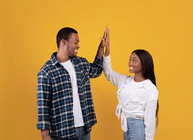 young generation z couple high-fiving