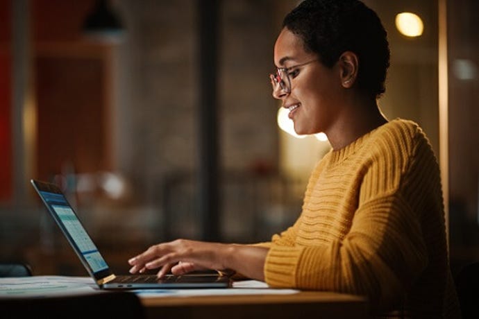 remote worker, a woman, working from home office on laptop