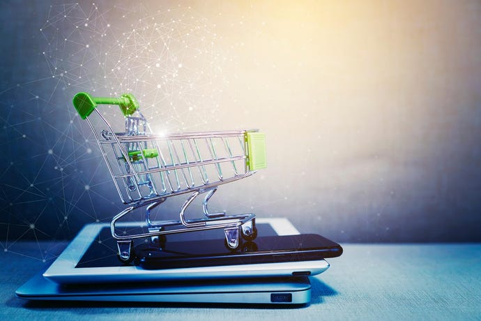 shopping cart on top of multiple devices used to make online purchases