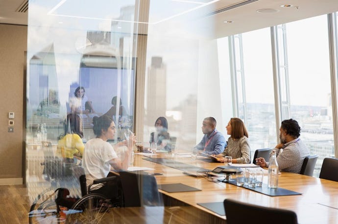 Business people in hybrid conference room meeting