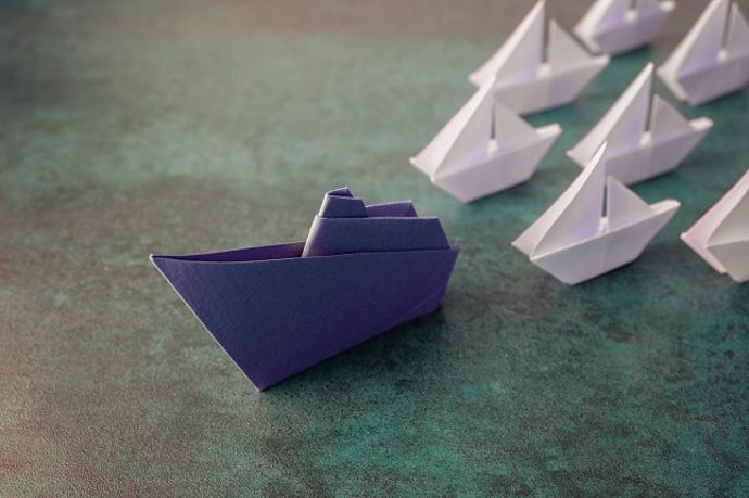 Origami paper ships, leadership concept