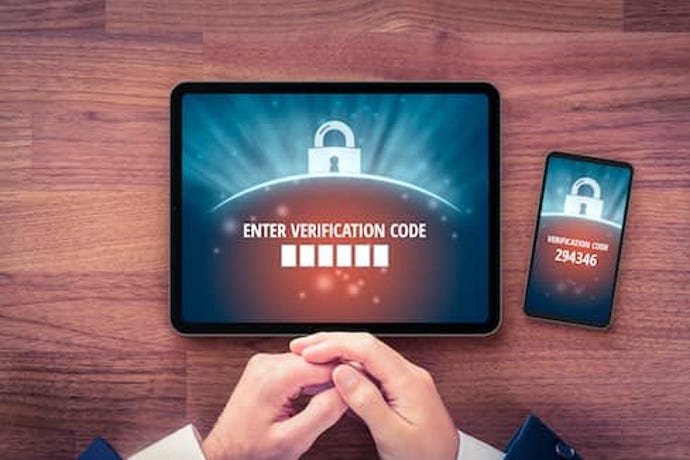 person on laptop waiting to type in second authentication numbers