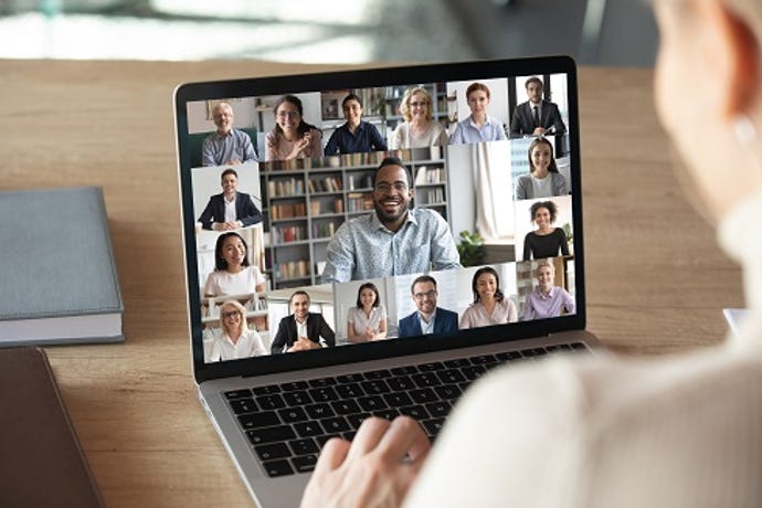 manager working from office managing remote team during a zoom meeting