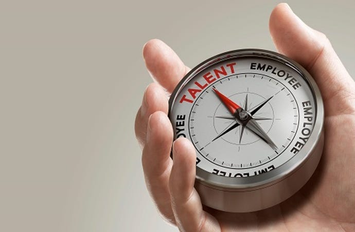 hand holding a "hiring" compass