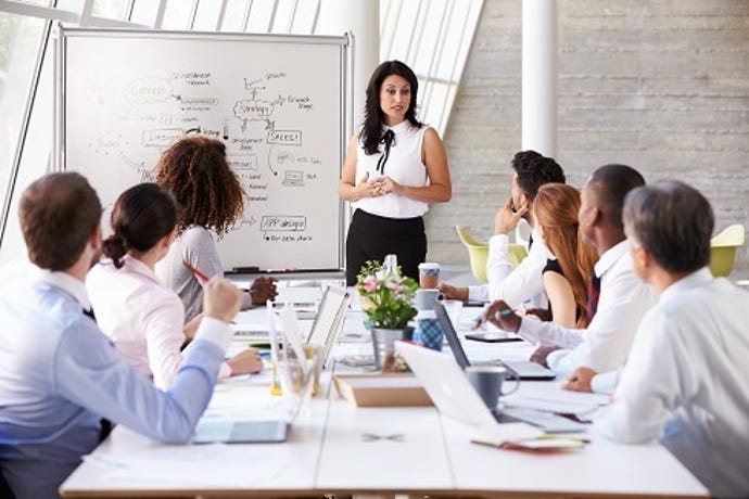 female business leader heading up a conference room meeting